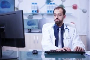 Doctor reviewing patient data on a computer related to Wound VAC CPT Code documentation and billing.