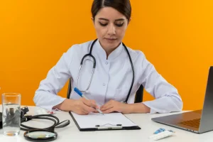 Doctor reviewing paperwork and writing on a form, illustrating TPI number use in medical billing documentation